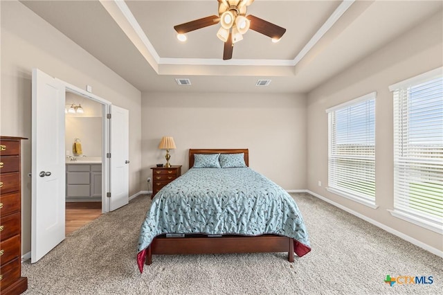 7109 Hammermill Ln, Temple, TX 76502 - carpeted bedroom featuring a raised ceiling, crown molding, ensuite bathroom, and ceiling fan
