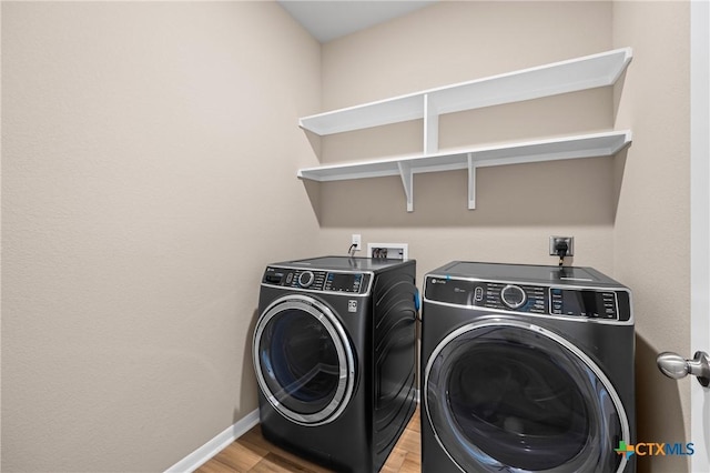 7109 Hammermill Ln, Temple, TX 76502 - laundry room featuring washer and clothes dryer and light wood finished floors