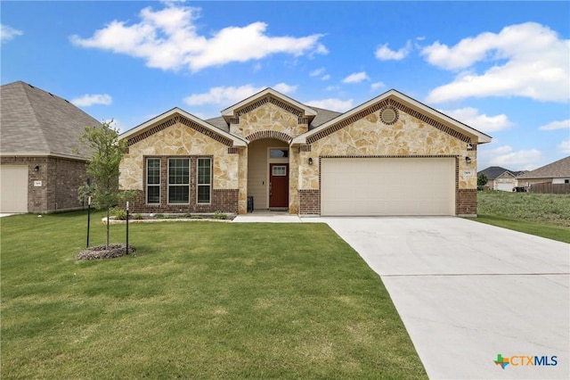 7109 Hammermill Ln, Temple, TX 76502 - view of front of house with an attached garage, concrete driveway, a front yard, stone siding, and brick siding