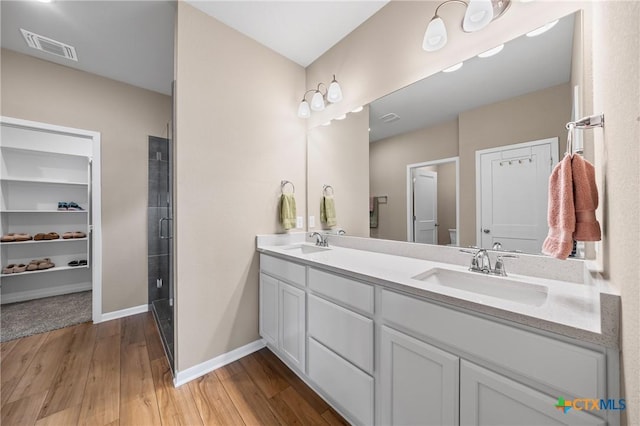 7109 Hammermill Ln, Temple, TX 76502 - bathroom featuring wood finished floors and double vanity