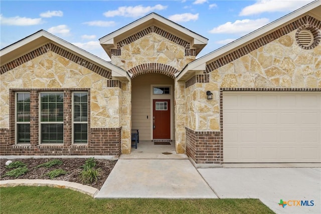 7109 Hammermill Ln, Temple, TX 76502 - doorway to property featuring stone siding and an attached garage