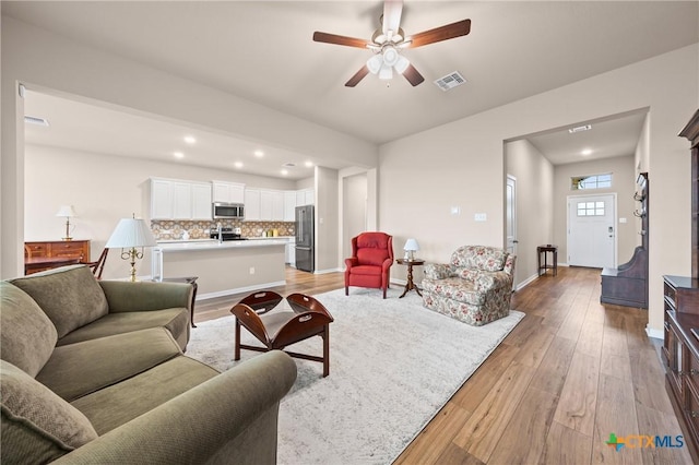7109 Hammermill Ln, Temple, TX 76502 - living room featuring light wood-style floors, a ceiling fan, and recessed lighting