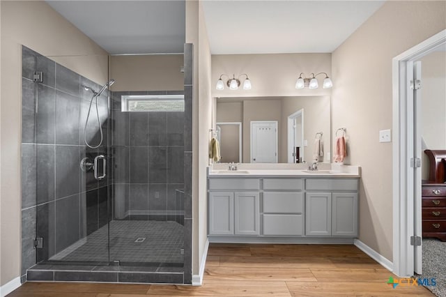 7109 Hammermill Ln, Temple, TX 76502 - full bath featuring double vanity, wood finished floors, and a shower stall