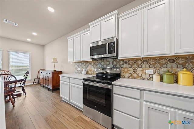 7109 Hammermill Ln, Temple, TX 76502 - kitchen featuring stainless steel appliances, light countertops, light wood finished floors, decorative backsplash, and recessed lighting
