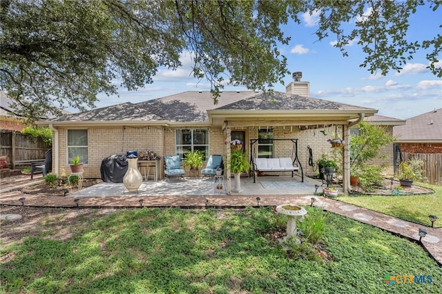 2903 Curtis Dr, Copperas Cove, TX 76522 - rear view of house featuring a patio area, brick siding, and a chimney