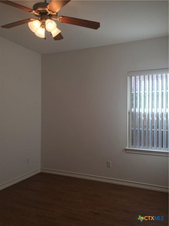 spare room with ceiling fan and dark hardwood / wood-style floors