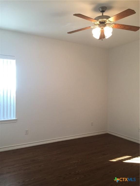 spare room featuring ceiling fan and dark hardwood / wood-style flooring