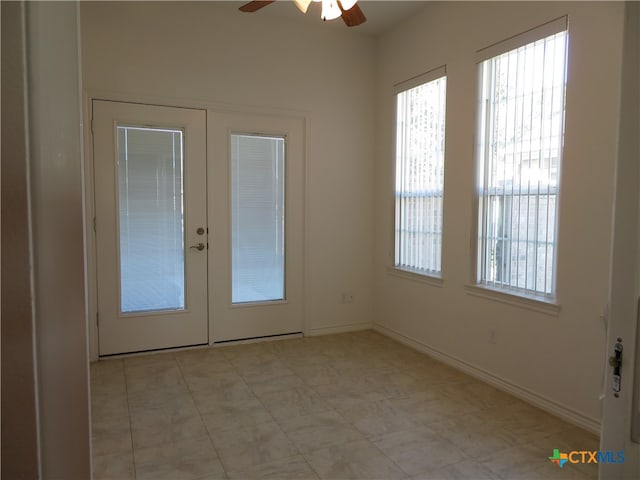 doorway to outside featuring ceiling fan and french doors