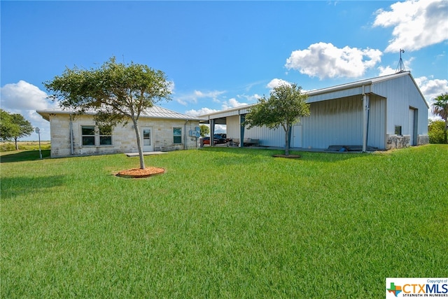 rear view of property featuring a yard