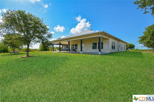 rear view of property featuring a yard