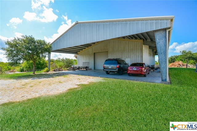 view of vehicle parking featuring a garage and a yard