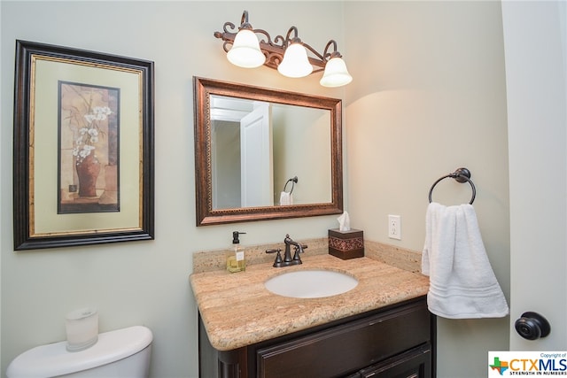 bathroom featuring toilet and vanity