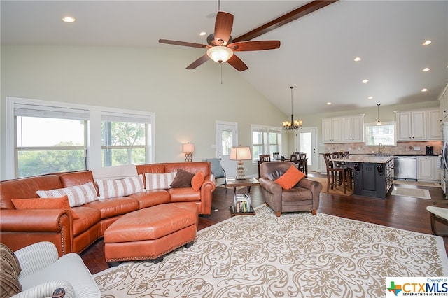 living room with high vaulted ceiling, light wood-type flooring, a healthy amount of sunlight, and ceiling fan with notable chandelier