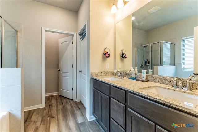 bathroom with vanity, an enclosed shower, and hardwood / wood-style flooring