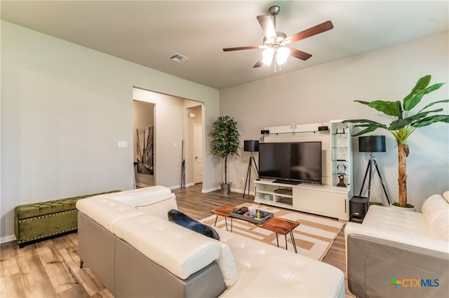 living room featuring light hardwood / wood-style flooring and ceiling fan