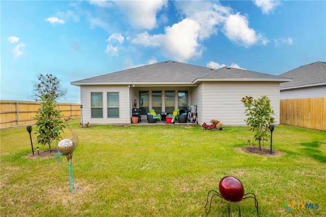 back of property featuring a patio and a lawn