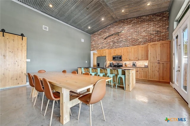 dining space featuring high vaulted ceiling, recessed lighting, visible vents, and finished concrete flooring