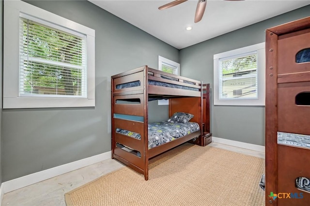 bedroom with baseboards and a ceiling fan