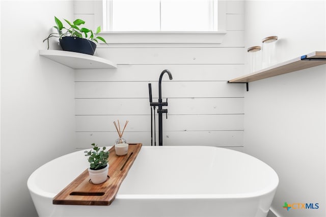 bathroom featuring a tub and a healthy amount of sunlight