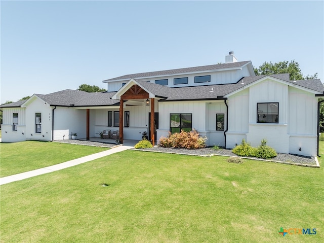 modern farmhouse style home with a patio area and a front lawn