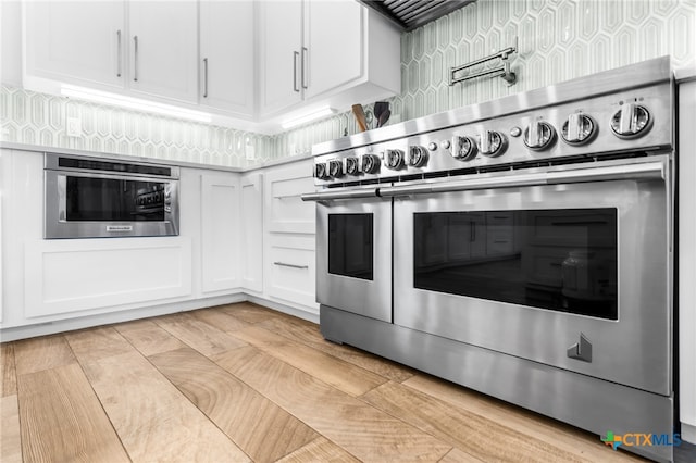 kitchen with white cabinets and appliances with stainless steel finishes