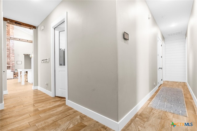 corridor with light wood-type flooring