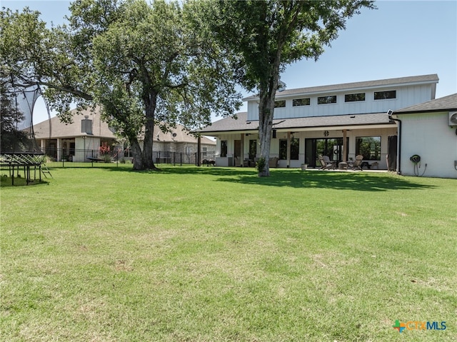 back of house featuring a yard