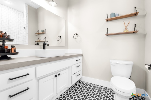 bathroom featuring tile patterned flooring, vanity, and toilet