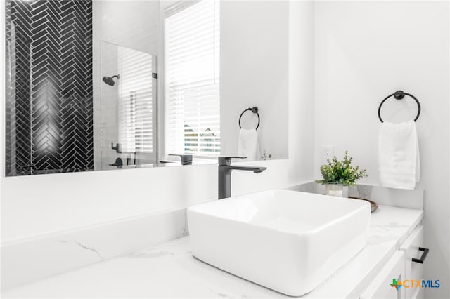 bathroom featuring vanity and a tile shower