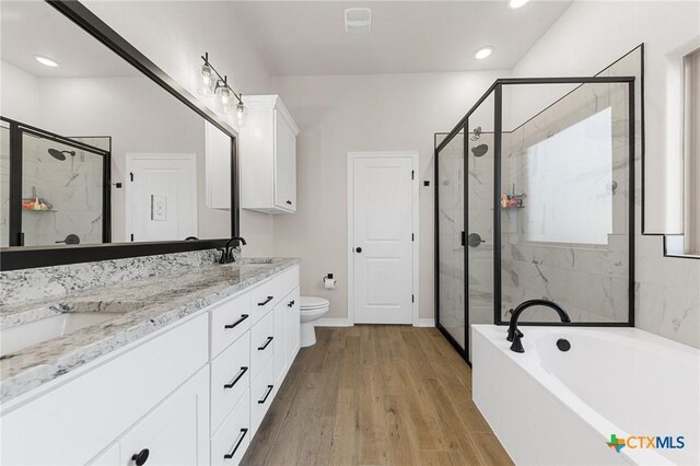 8917 Sassafras St, Temple, TX 76502 - bathroom featuring a stall shower, a bath, double vanity, toilet, and recessed lighting