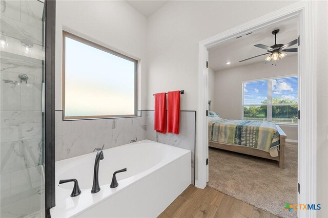 8917 Sassafras St, Temple, TX 76502 - ensuite bathroom featuring a bath, wood finished floors, a shower, and a ceiling fan