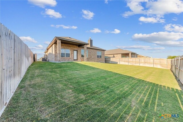 8917 Sassafras St, Temple, TX 76502 - back of house with brick siding, a chimney, and central AC