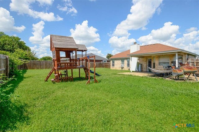 5005 Topsey Dr, Killeen, TX 76542 - fenced backyard featuring a playground and a patio area