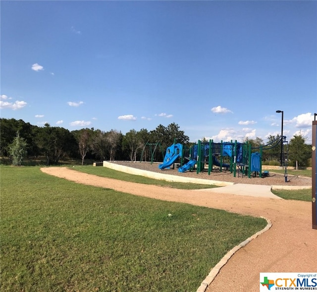 view of playground with a lawn