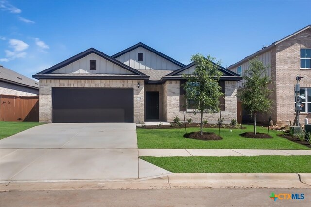 view of front facade with a garage and a front yard