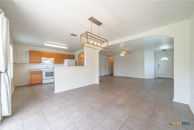 kitchen featuring hanging light fixtures, ceiling fan, white appliances, and light tile patterned flooring