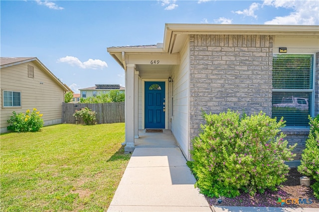 doorway to property with a yard