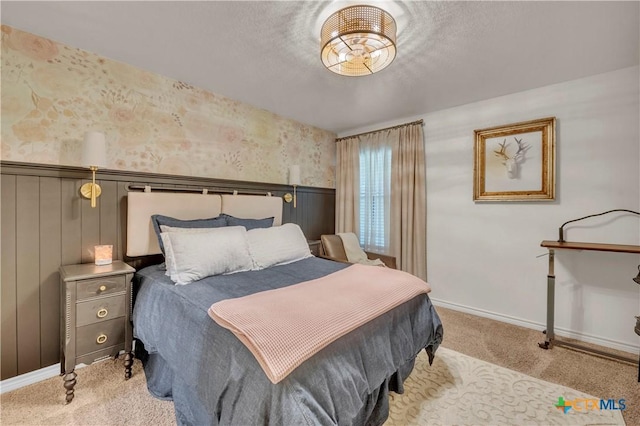 bedroom with wallpapered walls, carpet floors, a wainscoted wall, and baseboards