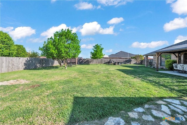 view of yard featuring a gazebo, a patio, and a fenced backyard