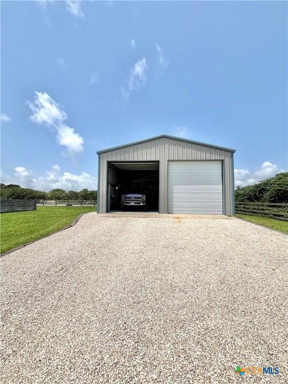 1007 N Washington Blvd, Port Oconnor, TX 77982 - detached garage featuring gravel driveway