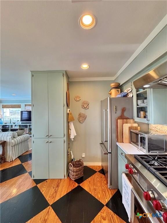 1007 N Washington Blvd, Port Oconnor, TX 77982 - kitchen featuring green cabinetry, appliances with stainless steel finishes, baseboards, light countertops, and open floor plan