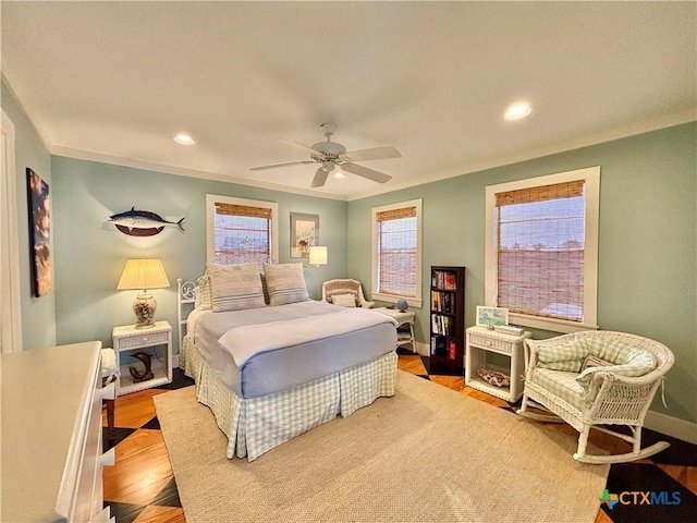 1007 N Washington Blvd, Port Oconnor, TX 77982 - bedroom featuring baseboards, wood finished floors, recessed lighting, ceiling fan, and ornamental molding