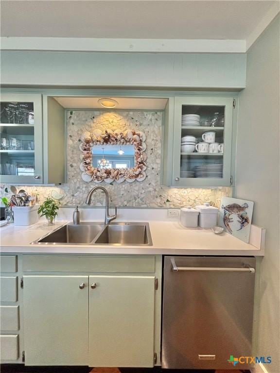 1007 N Washington Blvd, Port Oconnor, TX 77982 - kitchen featuring dishwasher, a sink, light countertops, and glass insert cabinets