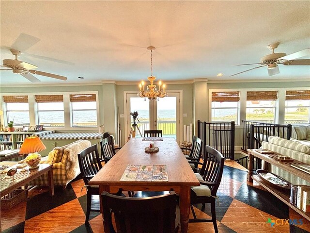 1007 N Washington Blvd, Port Oconnor, TX 77982 - dining area with a ceiling fan, crown molding, healthy amount of natural light, and wood finished floors
