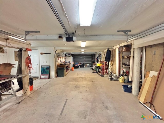 1007 N Washington Blvd, Port Oconnor, TX 77982 - garage with a workshop area and a garage door opener