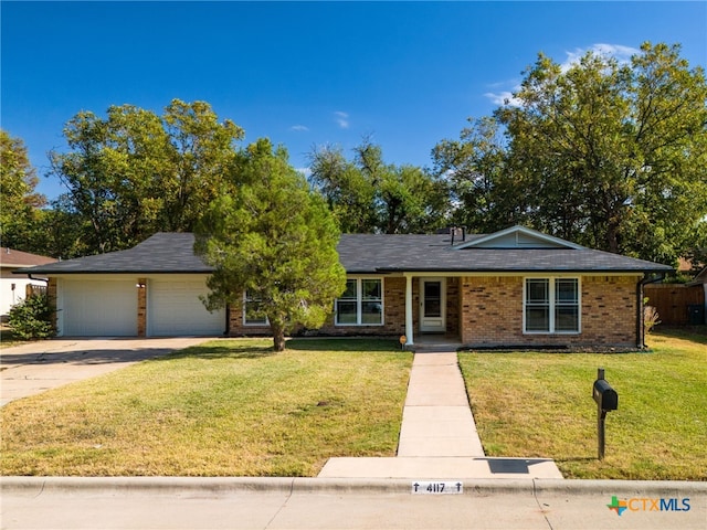 view of front of home with a garage and a front yard