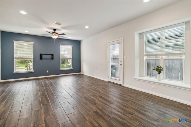 310 Spiny Lizard Ln, San Marcos, TX 78666 - spare room featuring dark wood-type flooring, a ceiling fan, recessed lighting, and baseboards