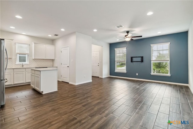310 Spiny Lizard Ln, San Marcos, TX 78666 - kitchen featuring open floor plan, a center island, ceiling fan, decorative backsplash, and freestanding refrigerator