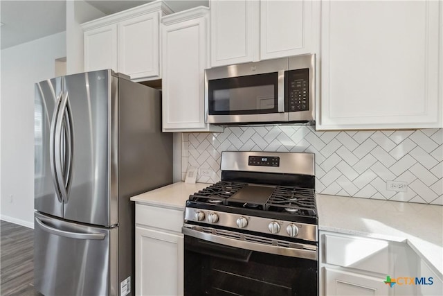 310 Spiny Lizard Ln, San Marcos, TX 78666 - kitchen featuring stainless steel appliances, light countertops, and white cabinets