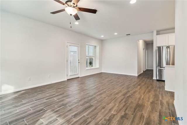 310 Spiny Lizard Ln, San Marcos, TX 78666 - unfurnished living room featuring dark wood-type flooring, a ceiling fan, baseboards, and recessed lighting